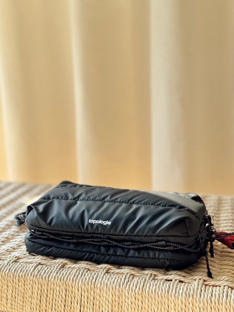 Topologie Puffed Messenger Bag Black (Category: Sling Bags) located in Mabalacat. Submitted by davidbianc04942 (Listing ID 1469100873, Image 3). Description: - Authentic Topologie black puffed messenger bag in pristine condition - Roomy multi-compartment design with secure zip closures - Eye-catching bright red interior lining with inside slip pockets and key leash - Adjustable black-and-white patterned rope strap featuring a red tag detail - Cle
