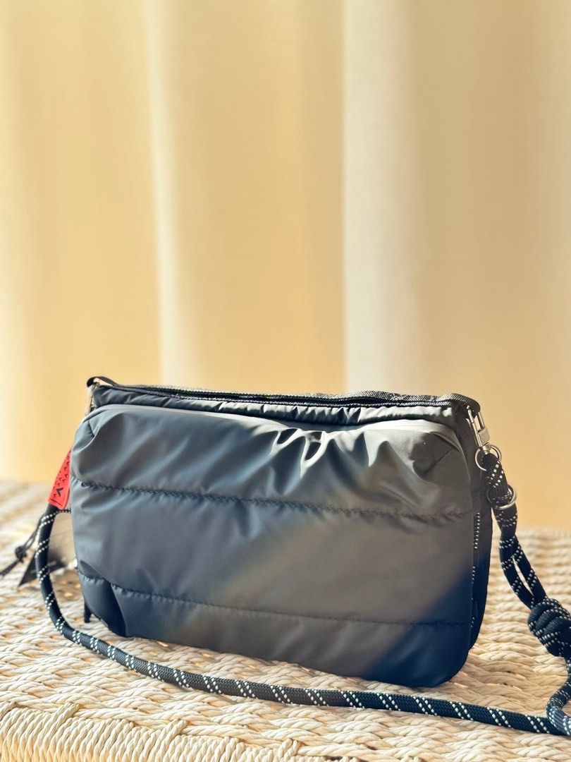 Topologie Puffed Messenger Bag Black (Category: Sling Bags) located in Mabalacat. Submitted by davidbianc04942 (Listing ID 1469100873, Image 2). Description: - Authentic Topologie black puffed messenger bag in pristine condition - Roomy multi-compartment design with secure zip closures - Eye-catching bright red interior lining with inside slip pockets and key leash - Adjustable black-and-white patterned rope strap featuring a red tag detail - Cle