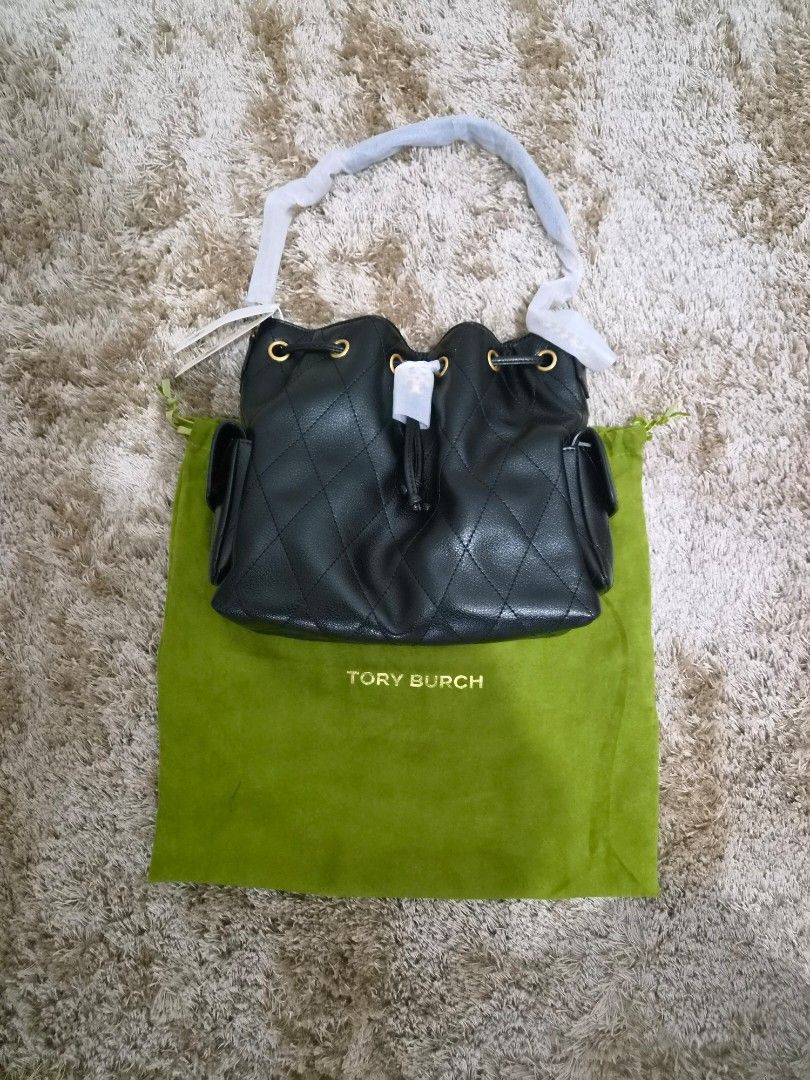 Tory Burch Black Charlie Bag (Category: Luxury Bags & Wallets) located in Paranaque City. Submitted by regf_01 (Listing ID 1469105746, Image 1). Description: Black quilted leather bucket bag from Tory Burch. Gold hardware details and drawstring closure. Includes side pockets, a matching green dust bag, and tags still attached. Removable shoulder strap wrapped in protective foam. .