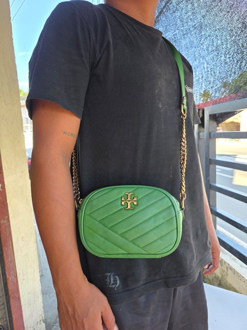 Tory Burch Green Kira Chevron Camera Bag (Category: Cross-body Bags) located in Lemery. Submitted by venus23 (Listing ID 1468930538, Image 1). Description: - Tory Burch camera bag in a stunning green shade - Crafted from premium leather with chic chevron quilting - Elegant gold-tone hardware and prominent front logo - Secure zip top closure - Measures approximately 7.5 inches across - Stylish mixed chain and leather strap - Roomy enough for your 