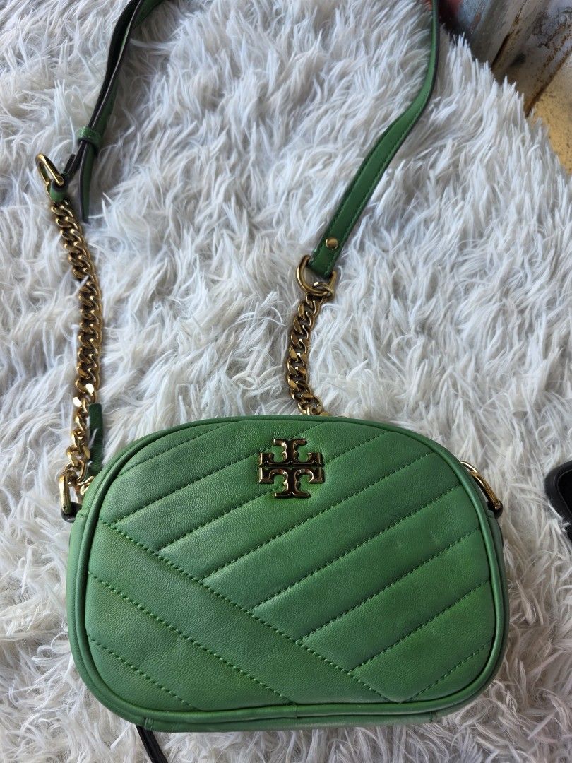 Tory Burch Green Kira Chevron Camera Bag (Category: Cross-body Bags) located in Lemery. Submitted by venus23 (Listing ID 1468930538, Image 2). Description: - Tory Burch camera bag in a stunning green shade - Crafted from premium leather with chic chevron quilting - Elegant gold-tone hardware and prominent front logo - Secure zip top closure - Measures approximately 7.5 inches across - Stylish mixed chain and leather strap - Roomy enough for your 