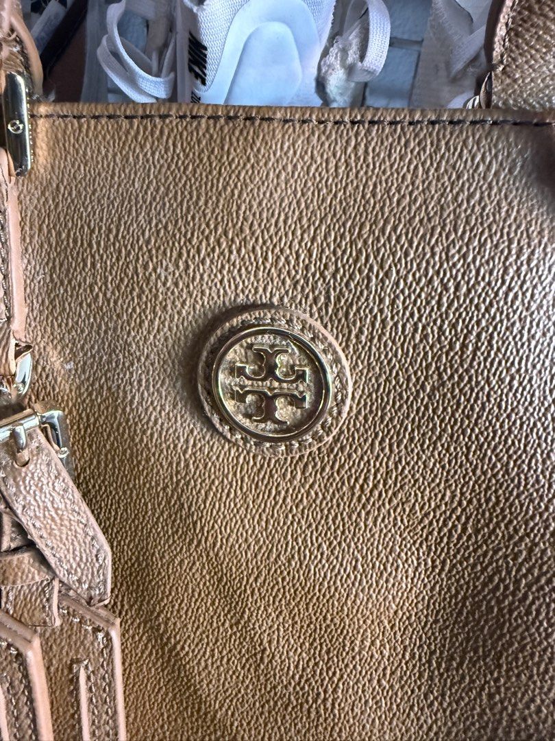 Tory Burch Tan Tote Bag with Gold Hardware (Category: Luxury Bags & Wallets) located in Manila. Submitted by keepercollection (Listing ID 1469048134, Image 2). Description: - Brand: Tory Burch - Material: Premium tan leather with all-over textured finish - Hardware: Gold-toned with engraved brand detailing on buckles - Design: Double top handles and hanging decorative luggage tags - Interior: Spacious, ideal for daily essentials - Condition: Mino
