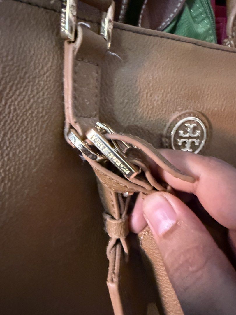 Tory Burch Tan Tote Bag with Gold Hardware (Category: Luxury Bags & Wallets) located in Manila. Submitted by keepercollection (Listing ID 1469048134, Image 3). Description: - Brand: Tory Burch - Material: Premium tan leather with all-over textured finish - Hardware: Gold-toned with engraved brand detailing on buckles - Design: Double top handles and hanging decorative luggage tags - Interior: Spacious, ideal for daily essentials - Condition: Mino