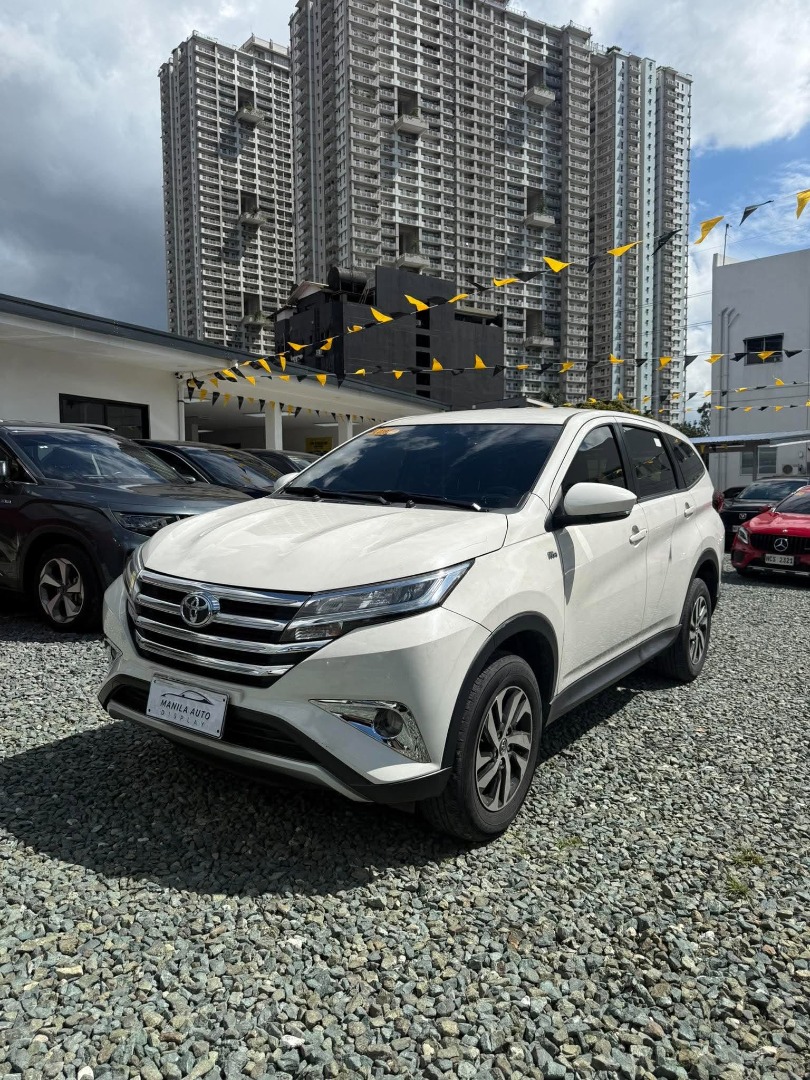 Toyota Rush E 1.5L Auto (Category: Used Cars) located in Pasig City. Submitted by pureocean-057512 (Listing ID 1468973349, Image 3). Description: 2018 TOYOTA RUSH E 1.5L GAS AUTOMATIC TRANSMISSION Downpayment: ₱142,848 White 61tkms mileage Automatic Transmission 5 ending plate Gasoline Engine 5 seater Fabric upholstery Automatic Climate Control with Rear Vents Touchscreen audio system Bluetooth connectivity & USB / AUX Adjustable Driver Seat & Co