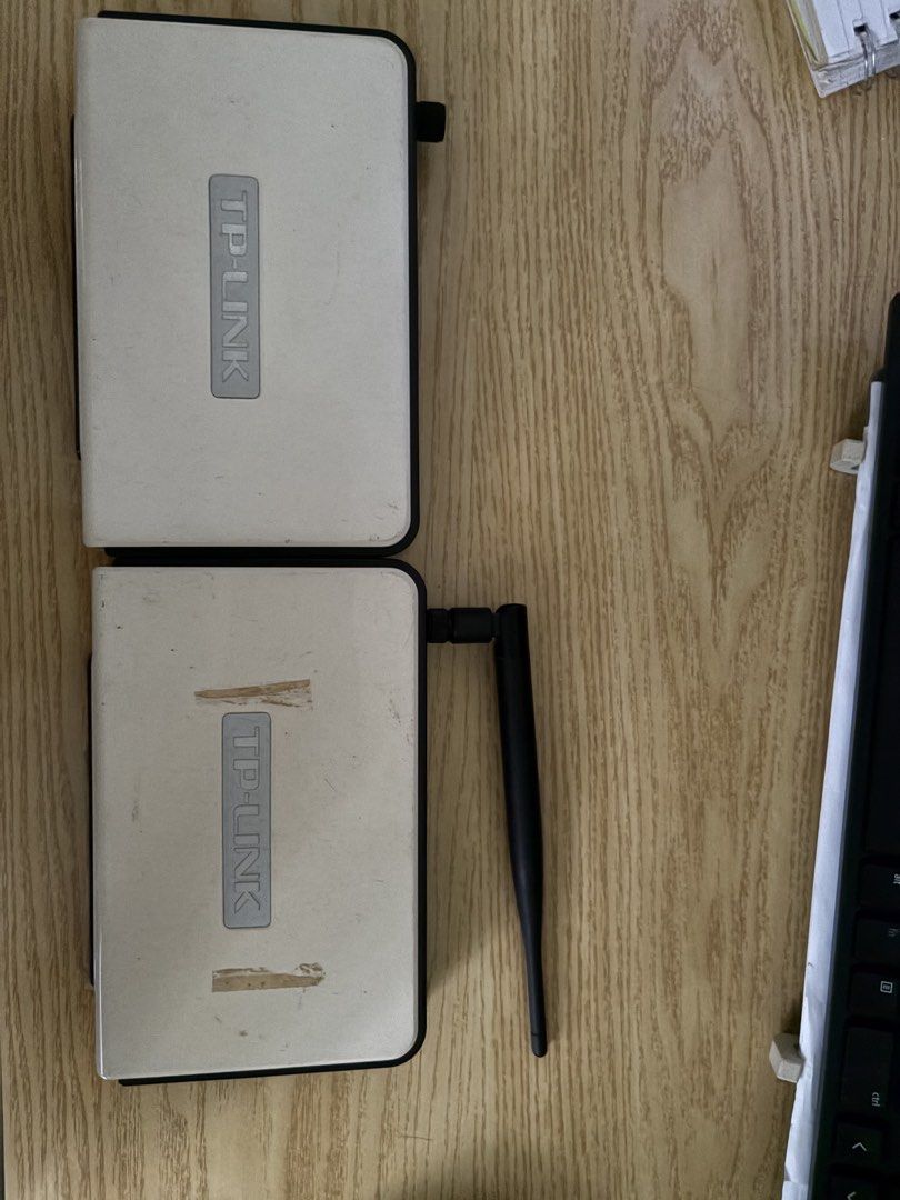 TP-Link Wireless Routers Set of Two (Category: Networking) located in Manila. Submitted by bstpcksmndl (Listing ID 1469159799, Image 1). Description: - Set of 2 TP-Link networking devices - Includes one black external antenna - Distinct white and black housing with silver logo plate - Cosmetic flaws: signs of wear, dust, and tape residue on top - Working status unknown (selling as-is, clearing out workspace).