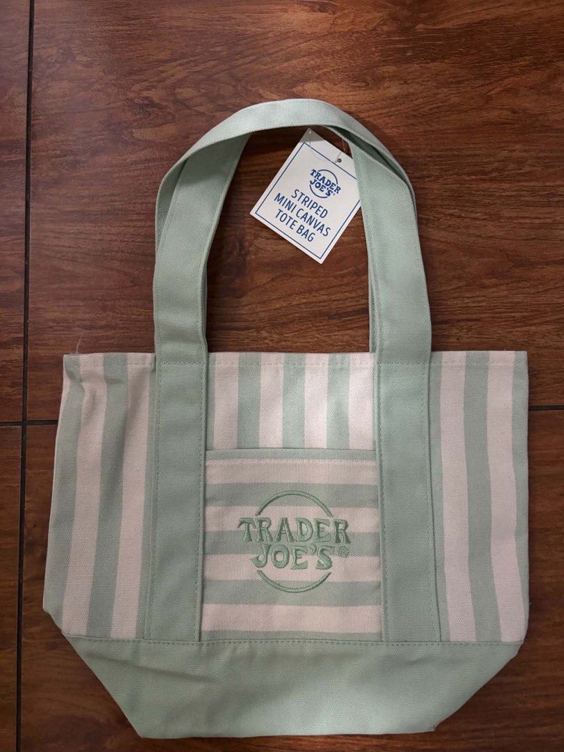 Trader Joe's Mini Canvas Tote Bag (Category: Tote Bags) located in Marilao. Submitted by pinhail (Listing ID 1469060316, Image 1). Description: s: 620 l: 799 - Authentic Trader Joe's mini canvas tote bags - Available colors: Striped green, plain purple, striped pink, and striped beige - Features: Small handles and a convenient front pocket with embroidered logo - Condition: Brand new with original paper tags attached on two of them - Perfect size