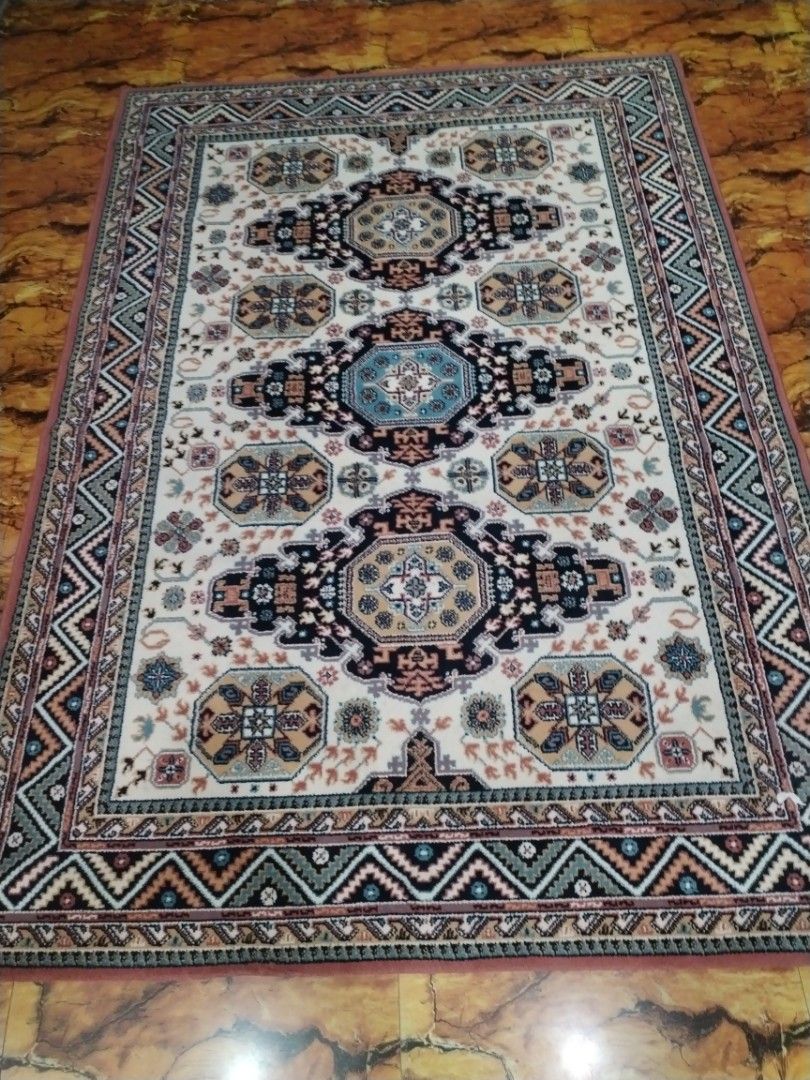 Traditional Oriental Style Area Rug Carpet (Category: Carpets, Mats & Flooring) located in Caloocan City. Submitted by rowely_jpn (Listing ID 1469021885, Image 1). Description: Large traditional area rug in clean condition. Features a cream background with blue, black, and beige geometric medallions and a zigzag border. Thick woven material, perfect for living rooms or bedrooms..