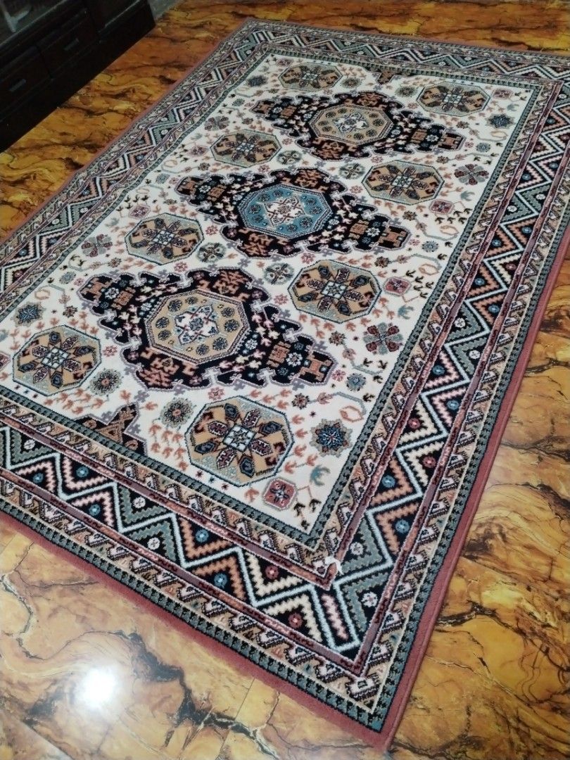 Traditional Oriental Style Area Rug Carpet (Category: Carpets, Mats & Flooring) located in Caloocan City. Submitted by rowely_jpn (Listing ID 1469021885, Image 2). Description: Large traditional area rug in clean condition. Features a cream background with blue, black, and beige geometric medallions and a zigzag border. Thick woven material, perfect for living rooms or bedrooms..