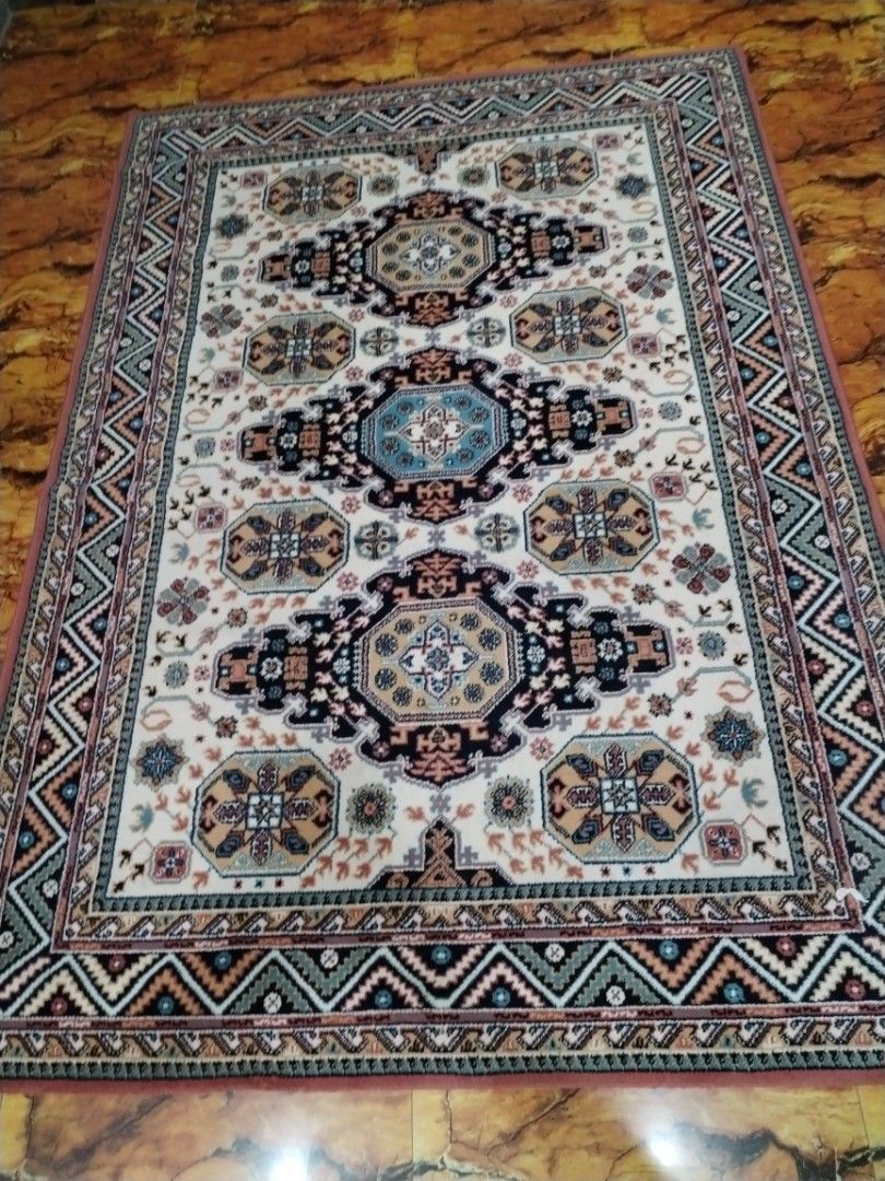 Traditional Oriental Style Area Rug Carpet (Category: Carpets, Mats & Flooring) located in Caloocan City. Submitted by rowely_jpn (Listing ID 1469021885, Image 3). Description: Large traditional area rug in clean condition. Features a cream background with blue, black, and beige geometric medallions and a zigzag border. Thick woven material, perfect for living rooms or bedrooms..