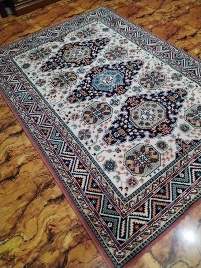 Traditional patterned area rug with geometric border (Category: Carpets, Mats & Flooring) located in Caloocan City. Submitted by rowely_jpn (Listing ID 1469099686, Image 3). Description: Japan surplus Area rug with intricate geometric and medallion patterns. Cream background with navy, blue, beige, and terracotta accents. Detailed zig-zag border design along the edges. Soft pile texture. Clean condition with no stains or damage visible. Ready to 