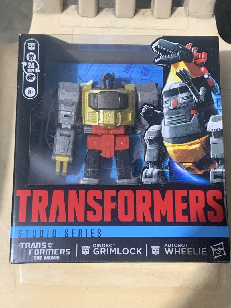 Transformers Studio Series 86 Dinobot Grimlock and Autobot Wheelie (Category: Action & Battle Toys) located in Taguig. Submitted by paradise.collections (Listing ID 1469154392, Image 1). Description: - Brand: Transformers Studio Series (The Movie) - Characters: Dinobot Grimlock and Autobot Wheelie - Condition: Brand New, Unopened Box, 100% Authentic - Features: Converts in 24 steps - Recommended Age: 8 years and up - Perfect for collectors and fa