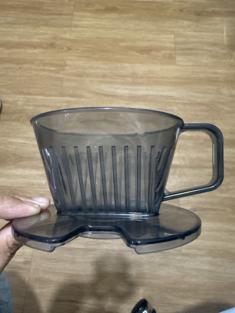 Transparent Grey Coffee Dripper Pour Over Brewer (Category: Coffee & Tea Tableware) located in Mandaluyong City. Submitted by merisellsyouwhat (Listing ID 1469083160, Image 1). Description: - Transparent grey coffee dripper with a convenient handle - Ribbed inner walls for fast and even coffee extraction - Flat bottom design with a wide base stand for stability - Perfect for your daily morning pour-overs - Easy to rinse and clean after brewing.