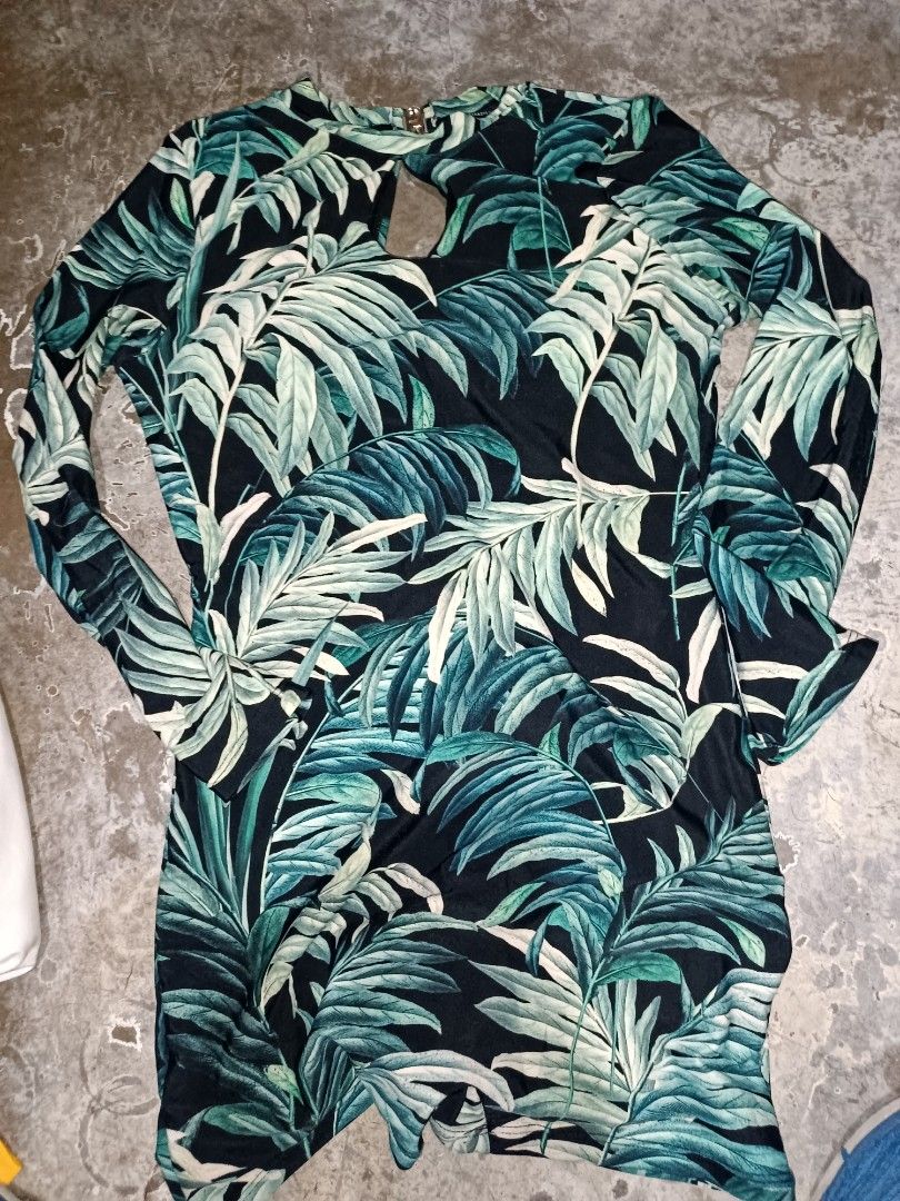 Tropical Leaf Print Long Sleeve Romper (Category: Rompers) located in Manila. Submitted by lorrrsz (Listing ID 1469108363, Image 3). Description: - Color & Pattern: Black with vibrant green tropical leaf print all over - Design: Mock neck with a stylish small keyhole cutout near the neckline - Closure: Convenient back zipper closure - Fit: Fitted silhouette with short bottoms - Perfect for: Casual days out, weekend parties, or tropical getaways.