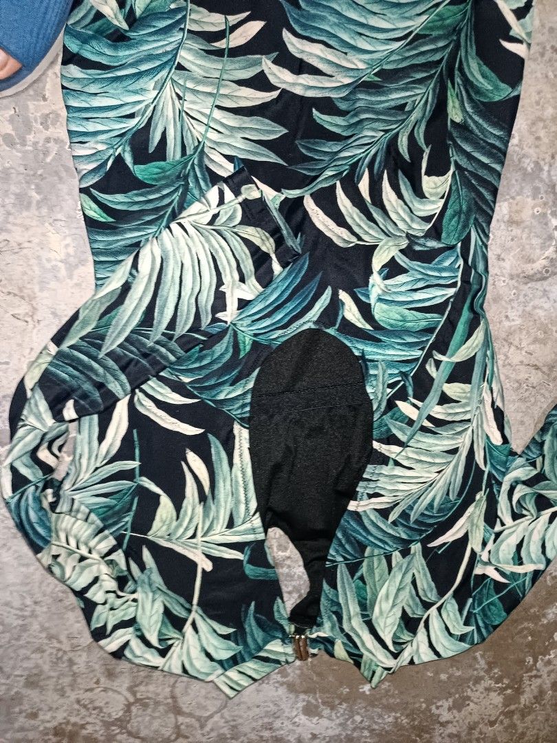 Tropical Leaf Print Long Sleeve Romper (Category: Rompers) located in Manila. Submitted by lorrrsz (Listing ID 1469108363, Image 2). Description: - Color & Pattern: Black with vibrant green tropical leaf print all over - Design: Mock neck with a stylish small keyhole cutout near the neckline - Closure: Convenient back zipper closure - Fit: Fitted silhouette with short bottoms - Perfect for: Casual days out, weekend parties, or tropical getaways.