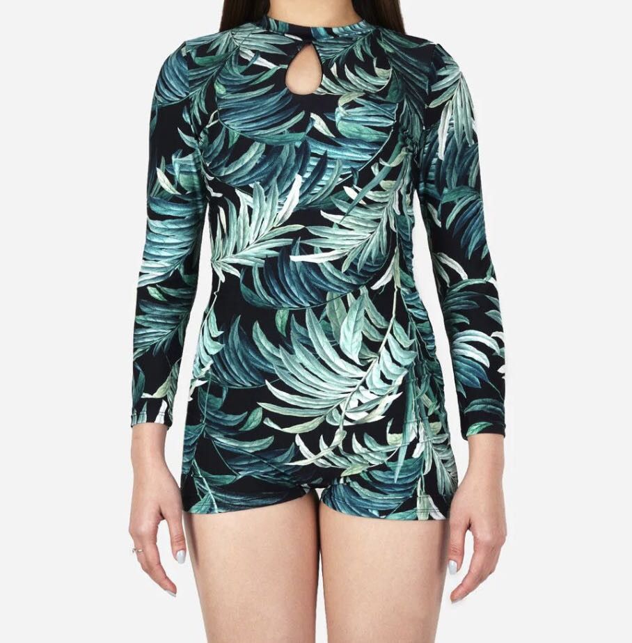 Tropical Leaf Print Long Sleeve Romper (Category: Rompers) located in Manila. Submitted by lorrrsz (Listing ID 1469108363, Image 1). Description: - Color & Pattern: Black with vibrant green tropical leaf print all over - Design: Mock neck with a stylish small keyhole cutout near the neckline - Closure: Convenient back zipper closure - Fit: Fitted silhouette with short bottoms - Perfect for: Casual days out, weekend parties, or tropical getaways.