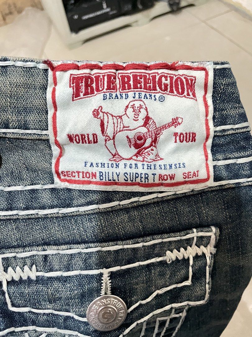 True Religion Billy Super T Jeans Size 25 (Category: Jeans) located in Iligan City. Submitted by farrisal (Listing ID 1468994740, Image 3). Description: - Brand: True Religion - Style: Billy Super T (Straight Leg) - Size: 25 - Color: Classic Blue Wash - Material: 99% Cotton, 1% Elastane (Made in USA) - Details: Signature thick white stitching, iconic horseshoe embroidery - Pockets: Flap pockets with secure button closures on the back - Condition:
