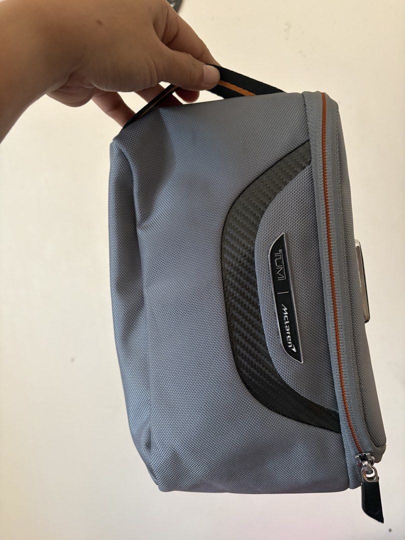 TUMI / Mclaren accessory kit (Category: Luxury Bags & Wallets) located in Manila. Submitted by kats_b (Listing ID 1468932535, Image 3). Description: - Authentic Coach clutch - Colorblock design: red, tan, and navy blue - Gold zipper - Small wrist strap - Tan interior with small pocket - Coach logo detail - Includes Coach tag with chain.
