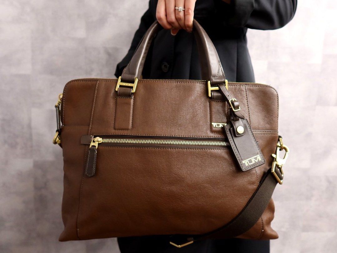 TUMI briefcase Laptop bag (Category: Luxury Bags & Wallets) located in Bacolod City. Submitted by garagehunterbuyandsale (Listing ID 1468954046, Image 1). Description: Tumi Beacon Hill Branch Slim Laptop Briefcase or Beacon Hill Irving Slim Leather Briefcase crafted from full-grain leather with gold-tone hardware • Material: Dark brown full-grain leather • Hardware: Gold-tone metal accents and zippers • Carry Options: Dual top leather grab handle