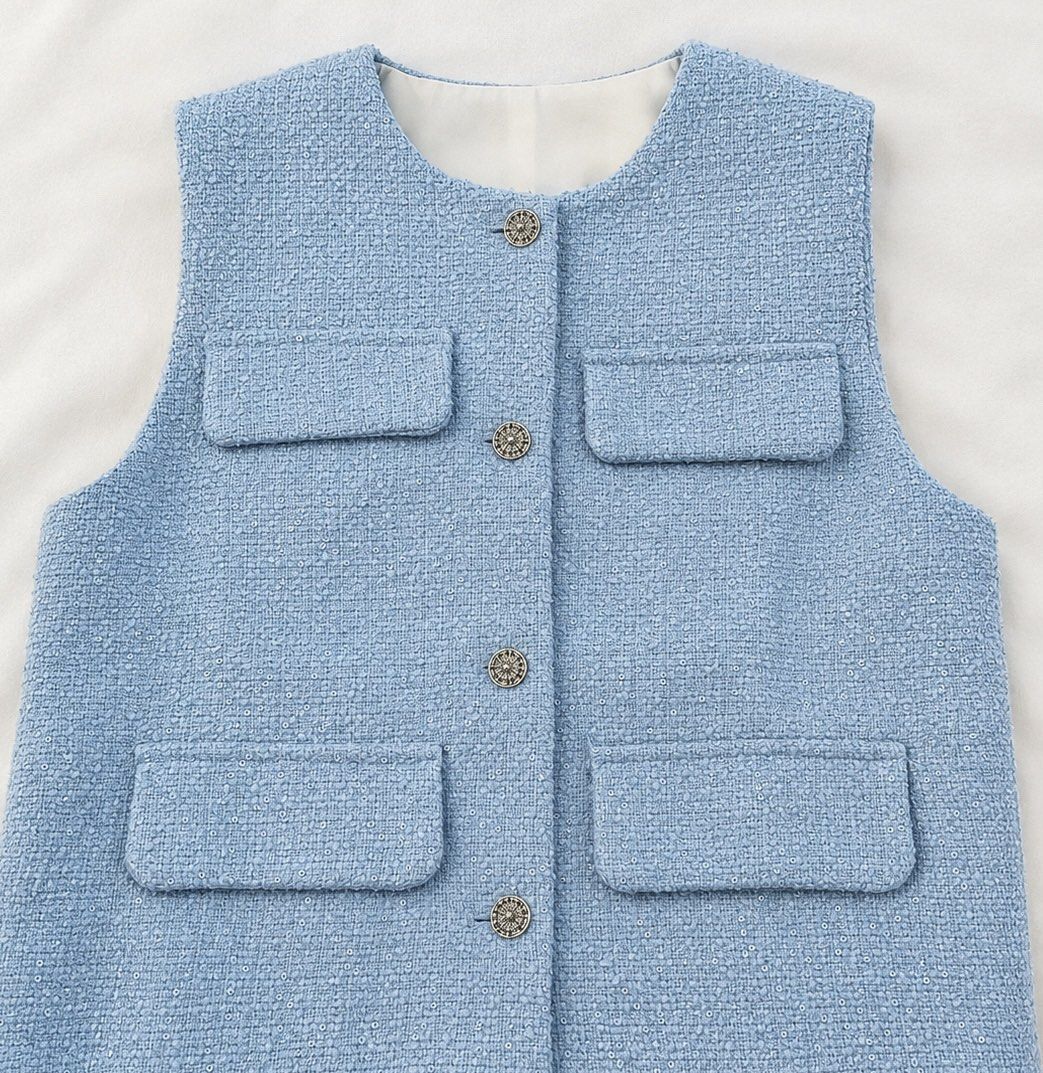 TWEED VEST (Category: Sleeveless) located in Manila. Submitted by nagets1001 (Listing ID 1469089300, Image 3). Description: - Style: Light blue tweed vest covered in all-over tiny sequins - Size: S (Brand new with tag attached) - Details: Round neckline, four front flap pockets, and ornate metal buttons - Design: Elegant white contrast hem lining and fully lined interior - Condition: Brand new, perfect for dressing up any outfit Can fit small to 