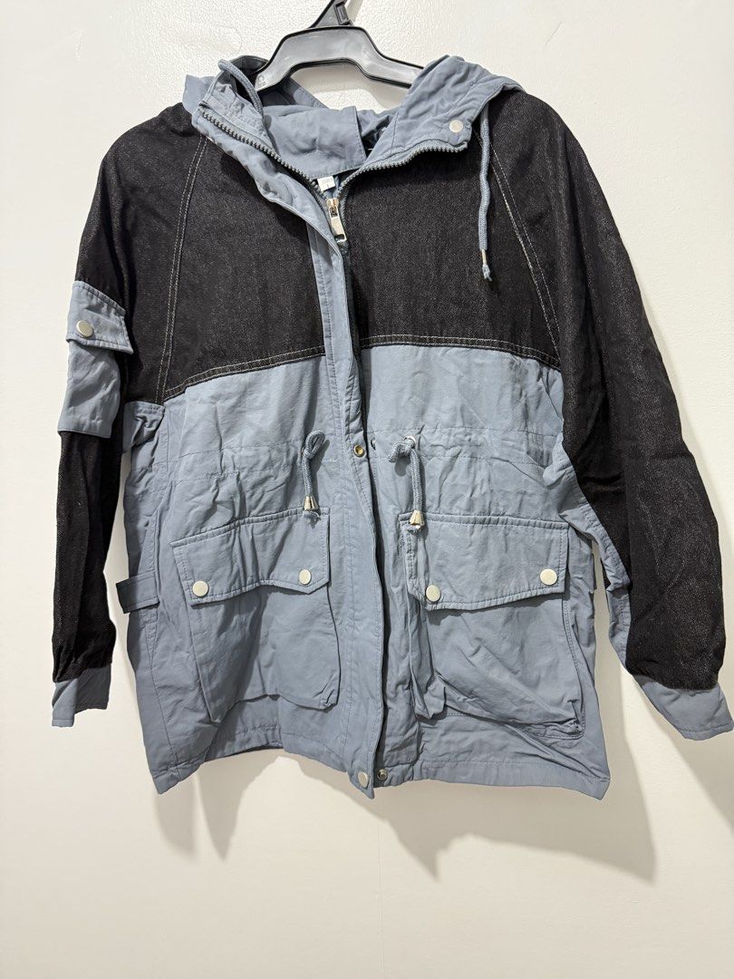 Two-Tone Denim and Grey Hooded Jacket with Pockets (Category: Coats, Jackets and Outerwear) located in Rodriguez. Submitted by prelovedbylalaine (Listing ID 1469102185, Image 1). Description: - Style: Two-tone casual outerwear (black denim top, grey cotton bottom) - Closure: Full front zipper - Hood & Fit: Attached hood with drawstrings, adjustable waist drawstrings for a customized fit - Pockets: Multiple front utility pockets with snap buttons 