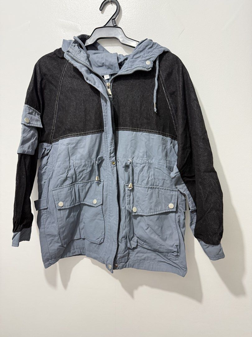 Two-Tone Denim and Grey Hooded Jacket with Pockets (Category: Coats, Jackets and Outerwear) located in Rodriguez. Submitted by prelovedbylalaine (Listing ID 1469102185, Image 2). Description: - Style: Two-tone casual outerwear (black denim top, grey cotton bottom) - Closure: Full front zipper - Hood & Fit: Attached hood with drawstrings, adjustable waist drawstrings for a customized fit - Pockets: Multiple front utility pockets with snap buttons 
