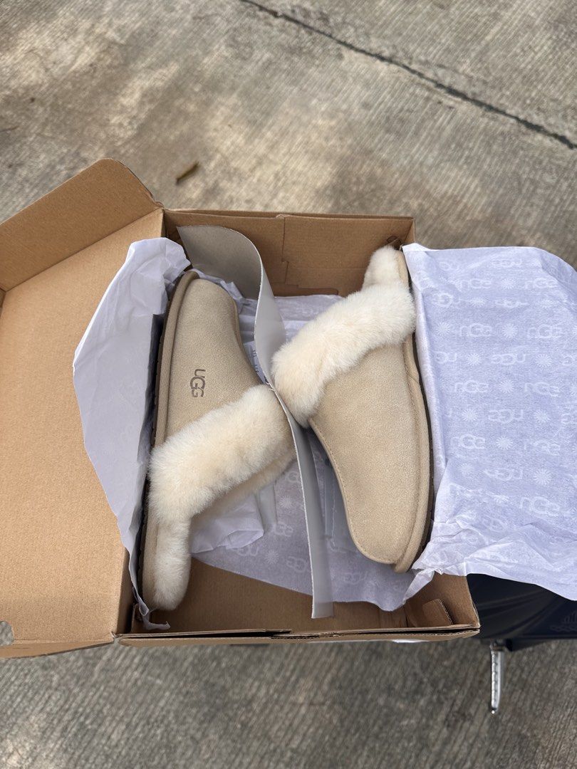 UGG W Scuffette II Slippers Sand Size 8 (Category: Slippers and slides) located in Dinalupihan. Submitted by helloimmikeee (Listing ID 1468992601, Image 1). Description: - Brand: UGG W Scuffette II - Color: Sand - Size: US 8 / EU 39 (25cm) - Material: Suede upper with cozy sheepskin collar - Condition: Brand new, unworn, fresh out of packaging - Inclusions: Original box and tissue paper included .