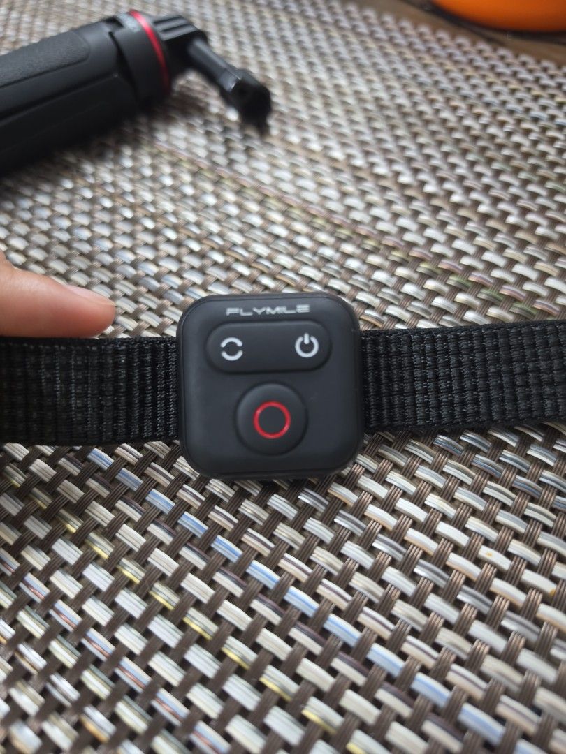 Ulanzi hand grip and Flymile remote control (Category: Tripods & Monopods) located in Quezon City. Submitted by littlemissrafaella (Listing ID 1468963031, Image 3). Description: - Brand/Item: Ulanzi black hand grip with standard action camera mount - Included: Flymile black remote controller with power, sync, and red record buttons - Convenience: Attached to a secure black fabric wrist strap with buckle closure - Condition: Clean and well-maintai
