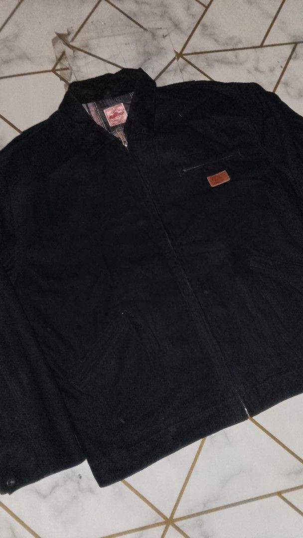 Uncle Fu Retro Workwear Zip Jacket (Category: Coats, Jackets and Outerwear) located in Rizal. Submitted by akosilelouh71119 (Listing ID 1468968919, Image 2). Description: - Brand: Retro Workwear by Uncle Fu - Color: Black canvas with grey and white plaid inner lining - Closure: Zip-up front with metal snap buttons - Pockets: Chest pocket with leather brand patch plus an extra zippered pocket - Style: Heavy-duty build, classic collar, solid street