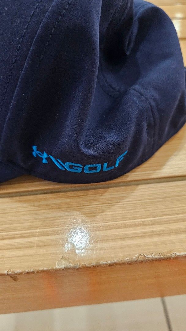 Under Armour Golf Cap Navy Blue (Category: Caps & Hats) located in Manila. Submitted by redbullhonda (Listing ID 1468955615, Image 2). Description: - Brand: Under Armour - Color: Navy blue with bright blue embroidered logo - Details: UA Golf embroidery on side, branded interior seam taping - Closure: Adjustable back strap - Condition: Clean fabric and stitching throughout.