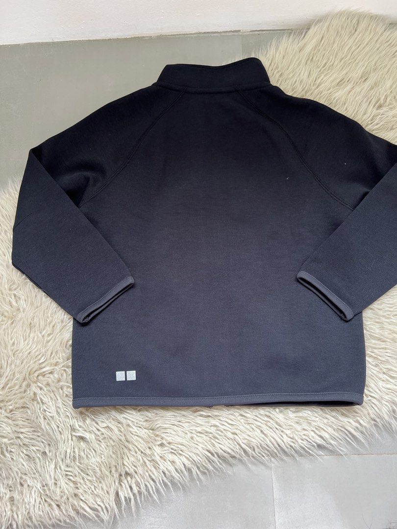 Uniqlo Black Zip-Up Jacket Size 110 (Category: Babies & Kids Fashion) located in Binan City. Submitted by finders_market (Listing ID 1468944873, Image 3). Description: - Brand: Uniqlo Kids - Size: 110 - Color: Solid black - Design: Full zip-up closure, high mock neck collar, and long raglan sleeves - Feature: Small reflective logo near the bottom hem for added visibility - Material: Smooth, stretchy, and lightweight fabric - Condition: Excellent 