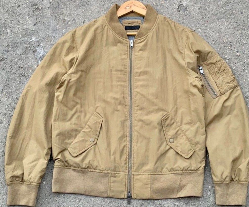Uniqlo Bomber Jacket (Brown) (Category: Coats, Jackets and Outerwear) located in Makati City. Submitted by bastybb (Listing ID 1469053913, Image 1). Description: DECLUTTERING! Selling for 500 only!! (negotiable) - Color: Khaki brown (neutral earth tone) - Size: 27.5L x 23W - Style: Classic flight bomber jacket - Material: Lightweight nylon with smooth lining - Closure: Full front zip with double pullers - Details: Ribbed collar, cuffs, and hem - 