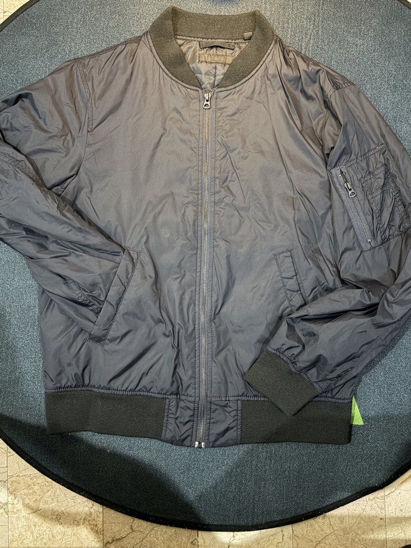 Uniqlo Bomber Jacket Size L (Category: Coats, Jackets and Outerwear) located in Quezon City. Submitted by dnarb (Listing ID 1469022742, Image 3). Description: - Brand: Uniqlo - Style: Classic black bomber jacket with zip-up front and sleeve pocket - Size: L (fits chest 96-104cm, height 175-185cm) - Material: 100% nylon and polyester shell/lining, with acrylic-spandex ribbing - Origin: Made in Vietnam - Condition: Excellent, ready to wear.