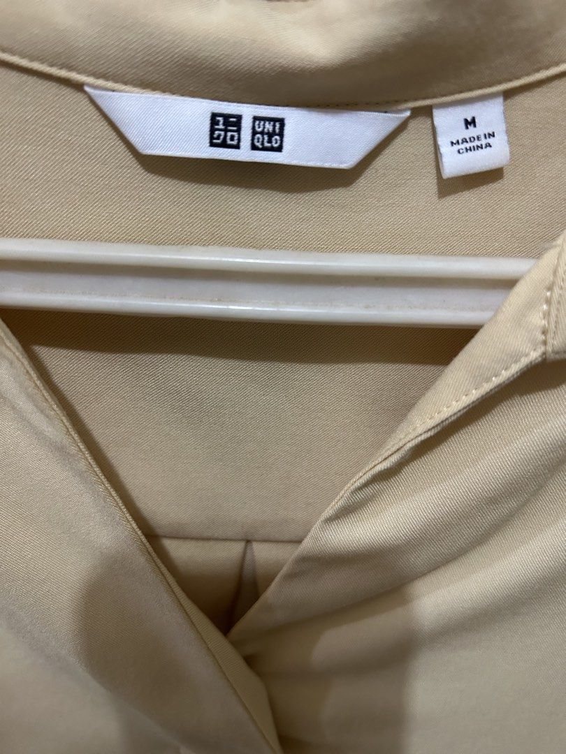 Uniqlo Light Beige Collared Blouse (Category: Blouses) located in Manila. Submitted by ab.mendoza (Listing ID 1468977379, Image 2). Description: - Brand: Uniqlo - Color: Light Beige - Size: M - Style: V-neck collared blouse, relaxed fit, 3/4 sleeves, curved high-low hem - Material: Smooth, professional fabric - Condition: Excellent - Perfect for office wear or smart-casual styling!.