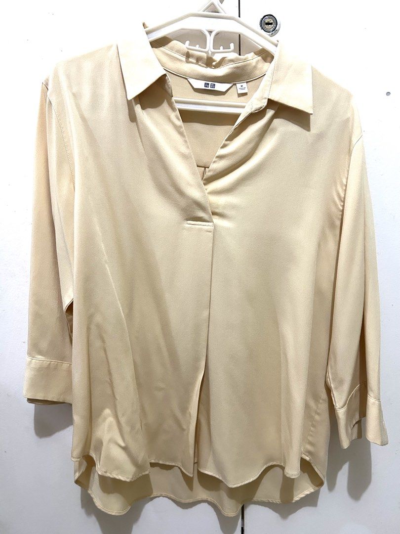 Uniqlo Light Beige Collared Blouse (Category: Blouses) located in Manila. Submitted by ab.mendoza (Listing ID 1468977379, Image 1). Description: - Brand: Uniqlo - Color: Light Beige - Size: M - Style: V-neck collared blouse, relaxed fit, 3/4 sleeves, curved high-low hem - Material: Smooth, professional fabric - Condition: Excellent - Perfect for office wear or smart-casual styling!.