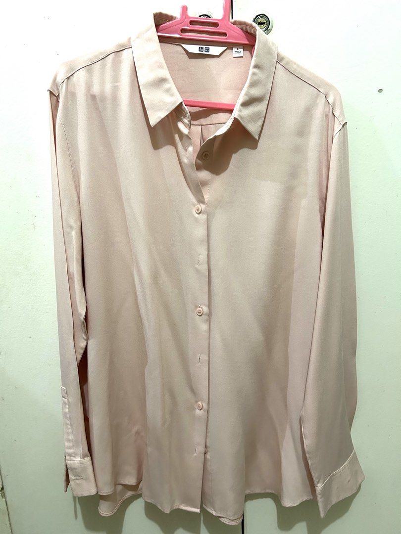 Uniqlo Pink Long Sleeve Button Up Blouse (Category: Longsleeves) located in Manila. Submitted by ab.mendoza (Listing ID 1468977613, Image 1). Description: - Brand: Uniqlo - Size: L - Color: Neutral pastel pink - Material: Smooth, silky fabric texture - Design: Button-down front, classic collar, and button cuffs - Fit: Loose and relaxed - Versatility: Easy to style for the office or keep casual with jeans - Origin: Made in China.