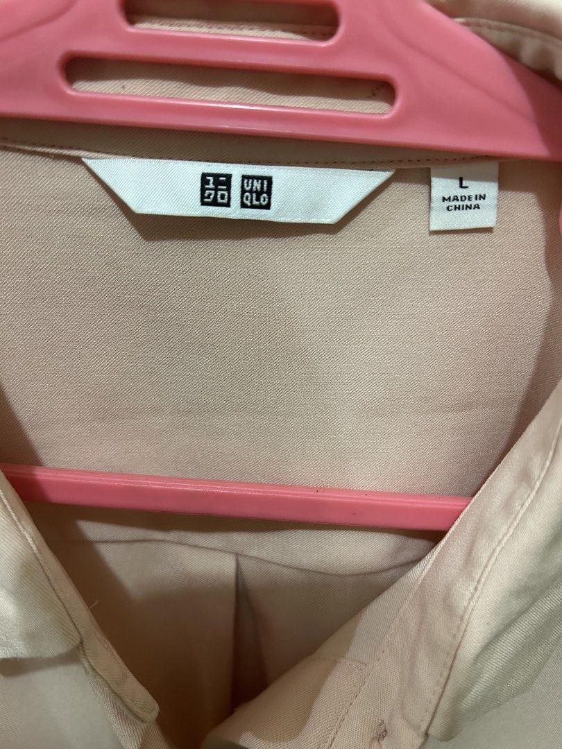 Uniqlo Pink Long Sleeve Button Up Blouse (Category: Longsleeves) located in Manila. Submitted by ab.mendoza (Listing ID 1468977613, Image 2). Description: - Brand: Uniqlo - Size: L - Color: Neutral pastel pink - Material: Smooth, silky fabric texture - Design: Button-down front, classic collar, and button cuffs - Fit: Loose and relaxed - Versatility: Easy to style for the office or keep casual with jeans - Origin: Made in China.