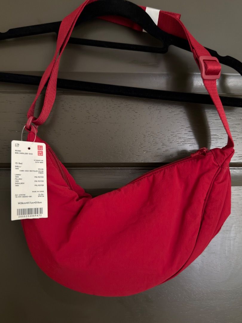 Uniqlo Round Mini Shoulder Bag Red (Category: Cross-body Bags) located in Calamba. Submitted by prongsiepoo (Listing ID 1469080691, Image 1). Description: - Brand new with original retail paper tag attached - Color: Vibrant solid red - Material: Soft and durable nylon fabric - Design: Trendy crescent shape with secure top zipper closure - Strap: Adjustable crossbody strap with buckle and plastic slider for a custom fit - 100% Authentic Uniqlo, hi