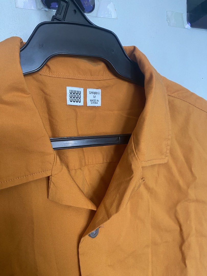 Uniqlo U Cuban Open Collar Polo (Category: Tshirts & Polo Shirts ) located in Manila. Submitted by antonvarga38504 (Listing ID 1468983684, Image 2). Description: - Brand: Uniqlo U - Item: Short sleeve button-up shirt - Color: Mustard yellow - Size: Men's Medium (M) - Design: Camp collar with front button closure - Condition: Clean fabric finish - Perfect for: Warm weather, casual wear, easy styling with denim or shorts.