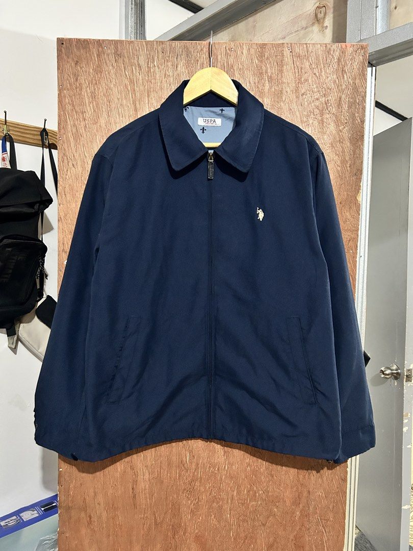 USPA Navy Blue Zip-Up Jacket (Category: Coats, Jackets and Outerwear) located in Davao. Submitted by orbetaarch23339 (Listing ID 1469120358, Image 1). Description: - Brand: USPA (United States Polo Assn.) - Color: Classic navy blue with light blue printed inner lining - Closure: Full zip with custom zipper pull - Features: Pointed collar, side pockets, interior care and style tags - Fit: Classic cut with clean, high-quality stitching - Condition: