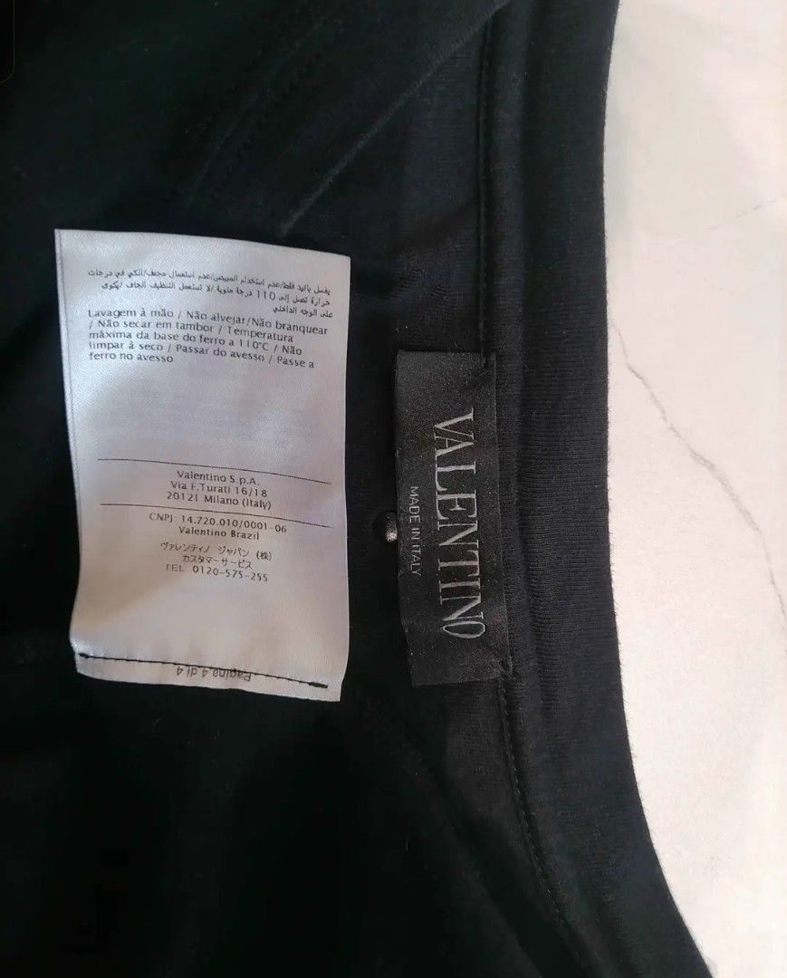 Valentino 2015 Eagle Wing T-Shirt (Category: Tshirts & Polo Shirts ) located in Manila. Submitted by gfinds. (Listing ID 1469071718, Image 3). Description: - Brand: Valentino - Color: Black - Material: 100% Cotton (Made in Italy) - Design: Engineered falcon and wing graphic print across front, shoulders, and back - Style: Short sleeves, crew neck - Era: Iconic mid-2010s luxury designer piece - Condition: Includes original wash care label and bran