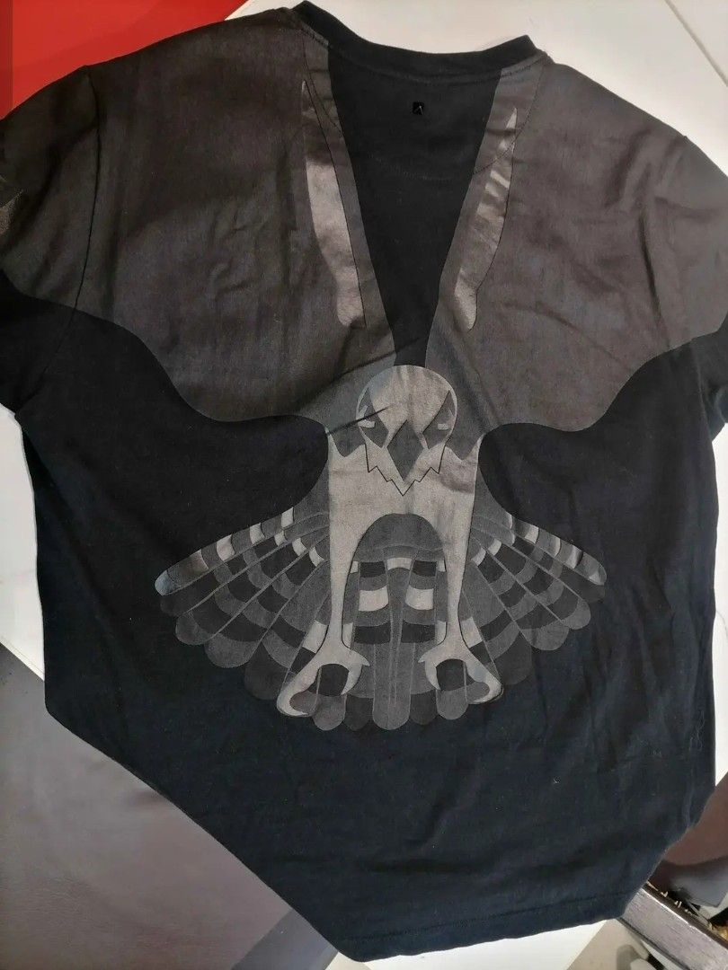 Valentino 2015 Eagle Wing T-Shirt (Category: Tshirts & Polo Shirts ) located in Manila. Submitted by gfinds. (Listing ID 1469071718, Image 1). Description: - Brand: Valentino - Color: Black - Material: 100% Cotton (Made in Italy) - Design: Engineered falcon and wing graphic print across front, shoulders, and back - Style: Short sleeves, crew neck - Era: Iconic mid-2010s luxury designer piece - Condition: Includes original wash care label and bran