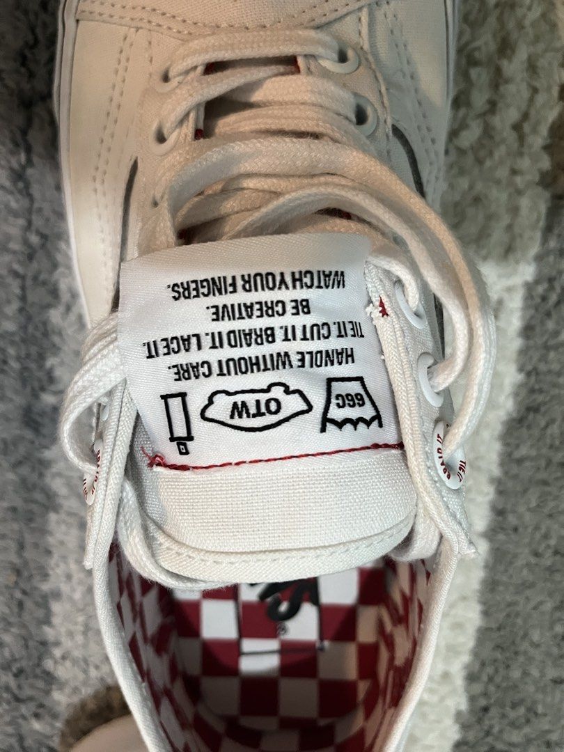 Vans Old Skool DIY White Sneakers (Category: Sneakers) located in Manila. Submitted by thriftpogu77014 (Listing ID 1468970132, Image 3). Description: - Model: Vans DIY Edition - Color: Classic Off-White canvas - Unique Details: 'Punch Here' stitching & subtle red accent stitching - Interior: Eye-catching red checkered lining - Branding: Custom tongue label with laundry-style graphics - Sole: Classic waffle rubber outsole - Inclusions: Comes with 