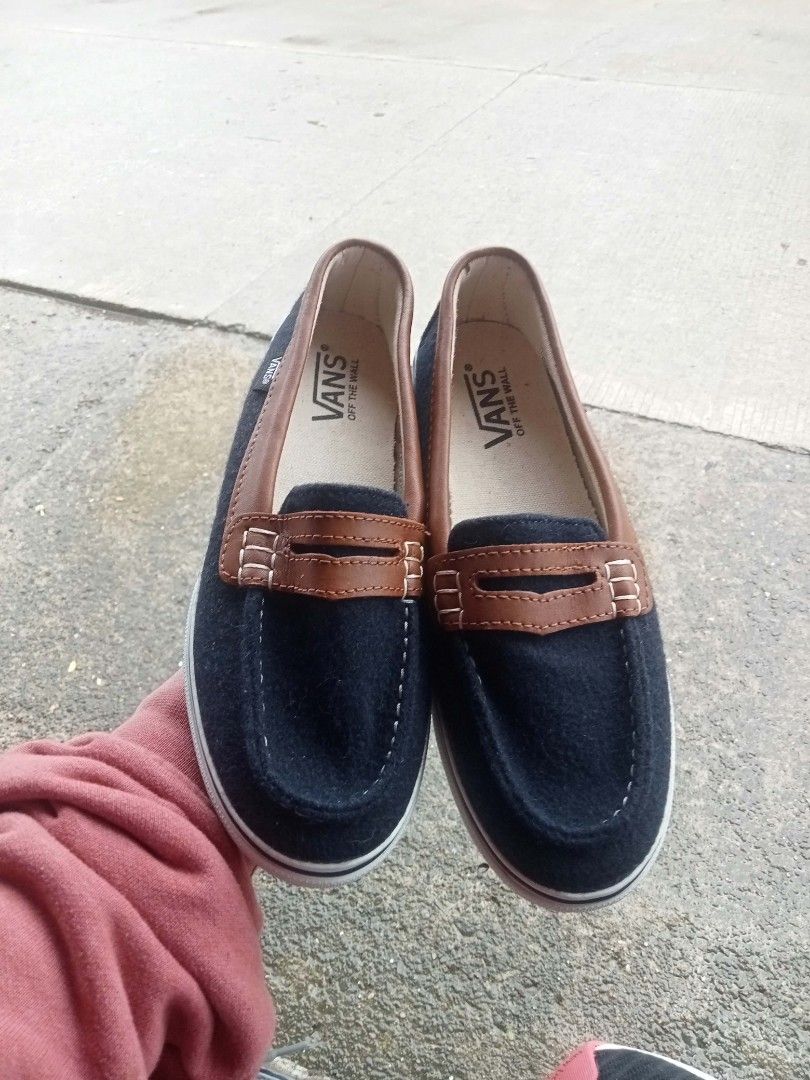 Vans Slip-On Loafers (Category: Loafers) located in Bontoc. Submitted by tedanzthrift (Listing ID 1469038814, Image 3). Description: - Brand: Vans - Style: Slip-on loafers - Color: Black and brown with white midsoles - Size: US 6 / EUR 36 / CM 23 - Features: Brown leather collar trim, penny loafer strap, and waffle soles with solid grip - Branding: 'Off the Wall' logo on heel and insoles - Condition: Clean overall, made in China.