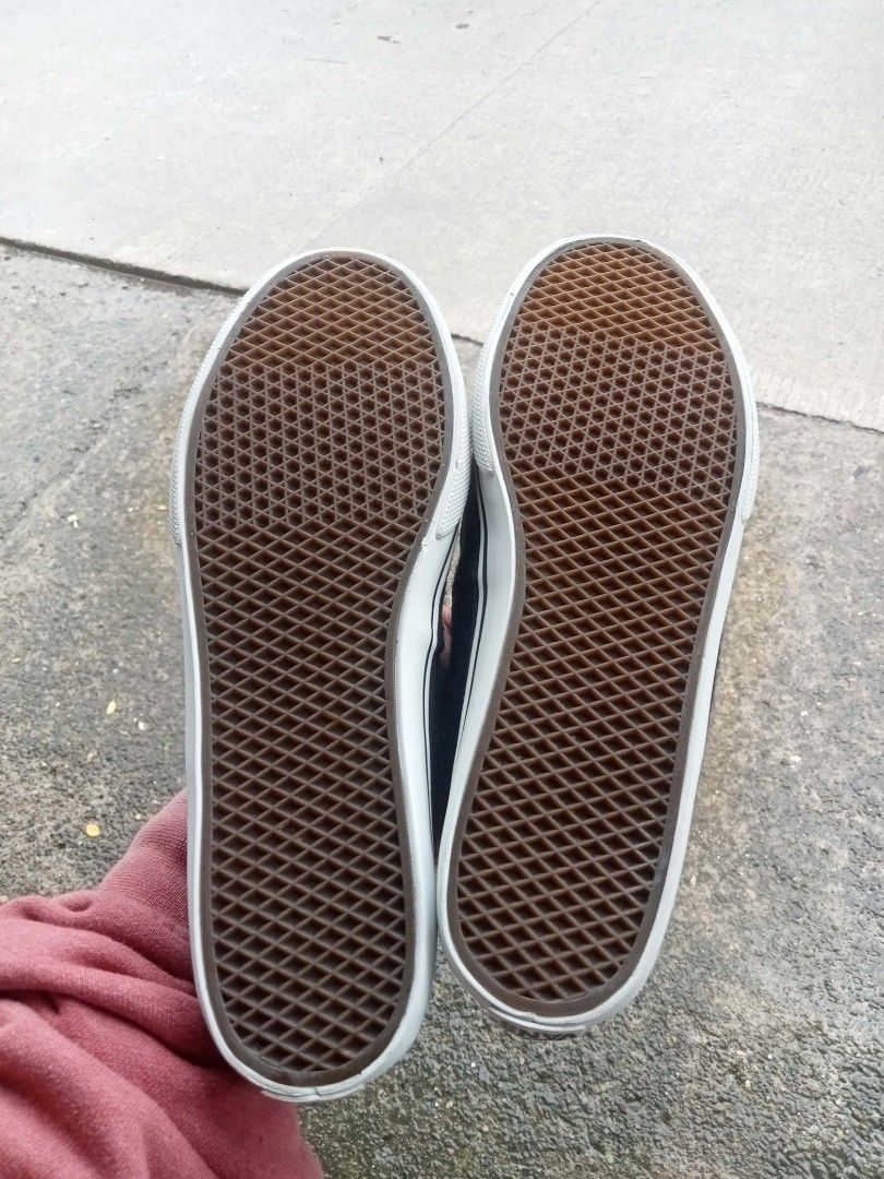 Vans Slip-On Loafers (Category: Loafers) located in Bontoc. Submitted by tedanzthrift (Listing ID 1469038814, Image 2). Description: - Brand: Vans - Style: Slip-on loafers - Color: Black and brown with white midsoles - Size: US 6 / EUR 36 / CM 23 - Features: Brown leather collar trim, penny loafer strap, and waffle soles with solid grip - Branding: 'Off the Wall' logo on heel and insoles - Condition: Clean overall, made in China.