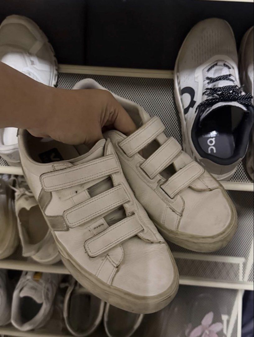 Veja Recife Velcro White Sneakers (Category: Sneakers) located in Manila. Submitted by frankietheresee (Listing ID 1468944476, Image 2). Description: - Brand: Veja - Style: Low-top sneakers with triple hook-and-loop (velcro) straps - Color: White leather with greyish signature V logo - Soles: Durable rubber soles - Condition: Pre-loved with visible wear, scuff marks on the upper, and yellowing on the midsoles - Functionality: All straps secure pr