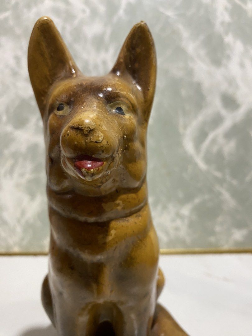 Vintage German Shepherd Ceramic Dog Statue (Category: Figurines & Statues) located in Calamba. Submitted by chebvintagedepot (Listing ID 1469027921, Image 2). Description: (B27-03) Vintage brown glazed ceramic or porcelain figurine of a German Shepherd sitting upright, with pointed ears and a red tongue. A nice decorative piece for dog lovers or collectors of vintage animal figurines. A lovely little piece to display on a shelf, desk, or in a col