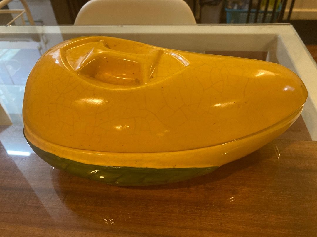 Vintage mango-shaped ceramic covered dish set with green leaf base (Category: Dinnerware & Cutlery) located in Quezon City. Submitted by ingga_preloved (Listing ID 1469018851, Image 2). Description: - Unique mango-shaped ceramic covered dish - Vibrant yellow gloss finish with green leaf design on the base - Features a stylish crackle glaze effect throughout - Includes two matching lids and two hollow bowl section - Versatile piece: great as home 