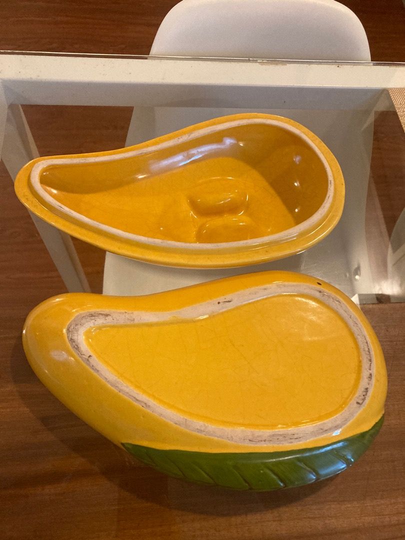 Vintage mango-shaped ceramic covered dish set with green leaf base (Category: Dinnerware & Cutlery) located in Quezon City. Submitted by ingga_preloved (Listing ID 1469018851, Image 3). Description: - Unique mango-shaped ceramic covered dish - Vibrant yellow gloss finish with green leaf design on the base - Features a stylish crackle glaze effect throughout - Includes two matching lids and two hollow bowl section - Versatile piece: great as home 