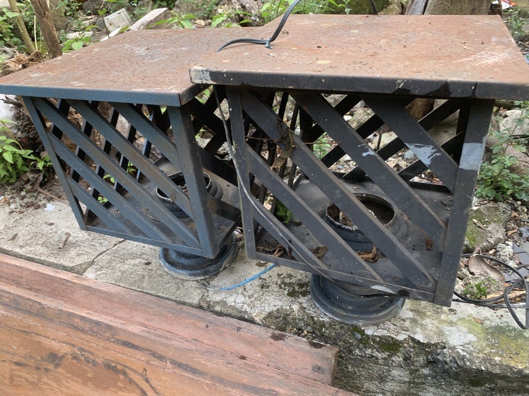 Vintage Metal Outdoor Lantern Lights Pair (Category: Lighting) located in Quezon City. Submitted by sojisup (Listing ID 1468991364, Image 2). Description: - Set of 2 metal outdoor lanterns - Features a charming diagonal lattice frame design - Includes attached bulb sockets and wiring - Condition: Heavy rust on top surfaces and debris inside the base - Ideal DIY restoration project before hanging up.