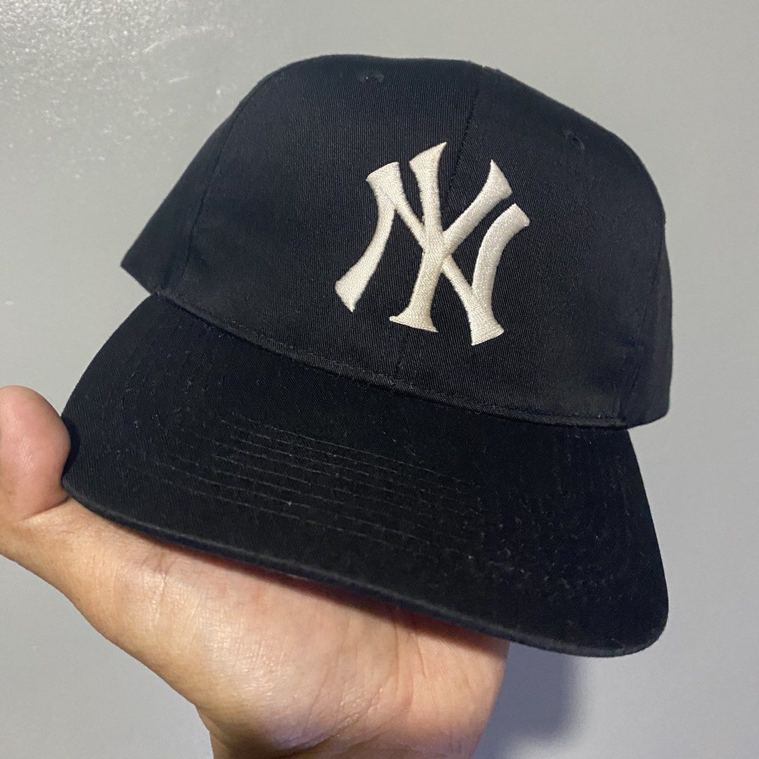 Vintage New York Yankees MLB Snapback Hat (Category: Caps & Hats) located in Cavite. Submitted by bong.ramos (Listing ID 1469075398, Image 1). Description: - Authentic New York Yankees baseball cap - Color: Classic black with white embroidered NY logo - Genuine merchandise tag attached inside - Adjustable snapback closure for a customized fit - Features a trendy grey undervisor - Versatile vintage streetwear staple, easy to style for daily wear -
